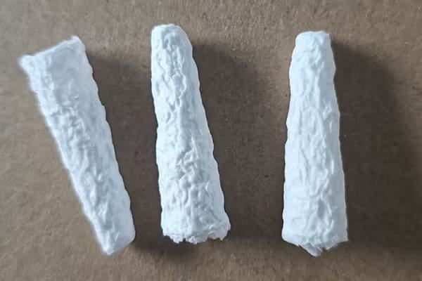 A large stock of packaged cellulose thimbles in a warehouse, ready for shipping