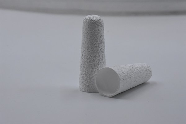 A caliper measuring the precise dimensions of a Soxhlet thimble